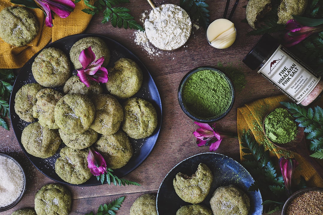 Matcha cookies home with powder matcha and fresh flowers around. 